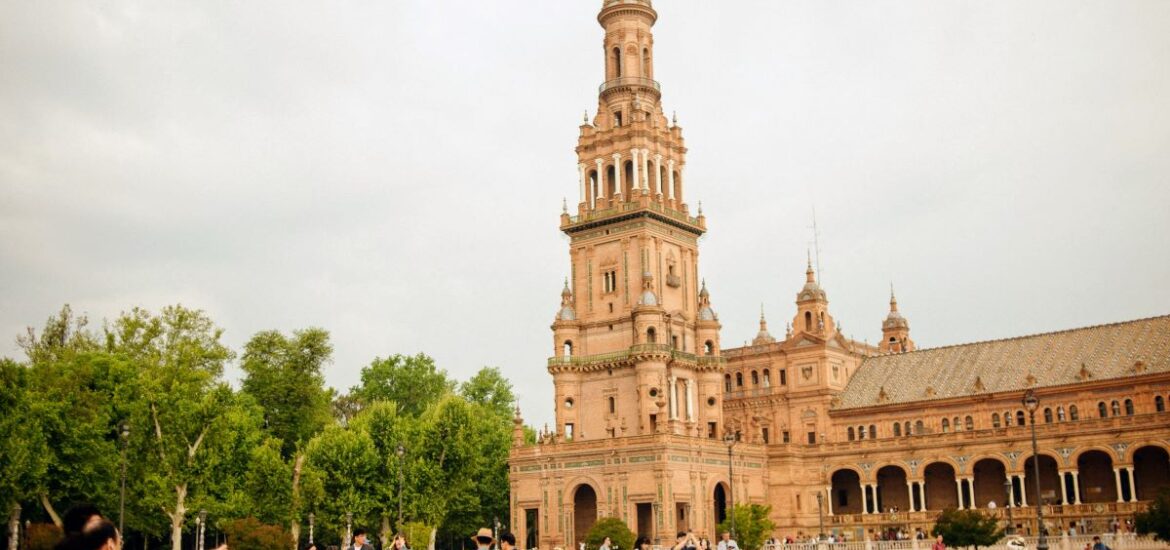 People walking through Plaza de España in October in Seville.