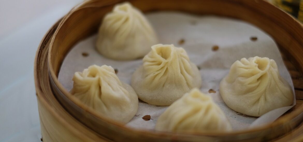 close up of dumplings in a bamboo steam basket