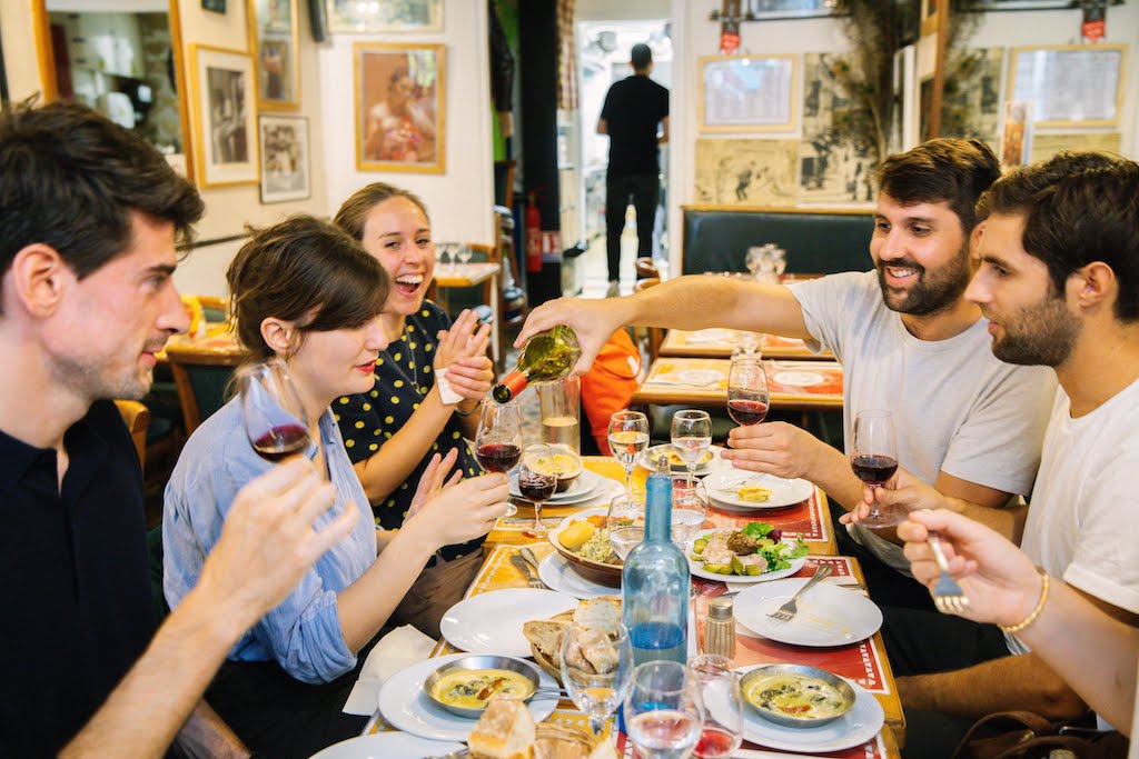 Group of diners at a Parisian restaurant with meal in Paris