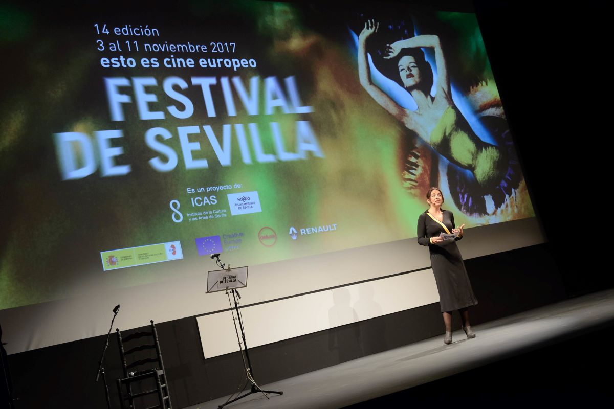 A woman giving a speech at the Sevilla Film Festival. 