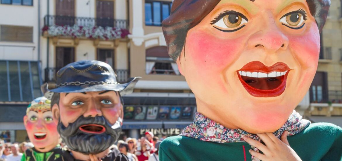 Three people wearing Cabezudos at Semana Grande in San Sebastian