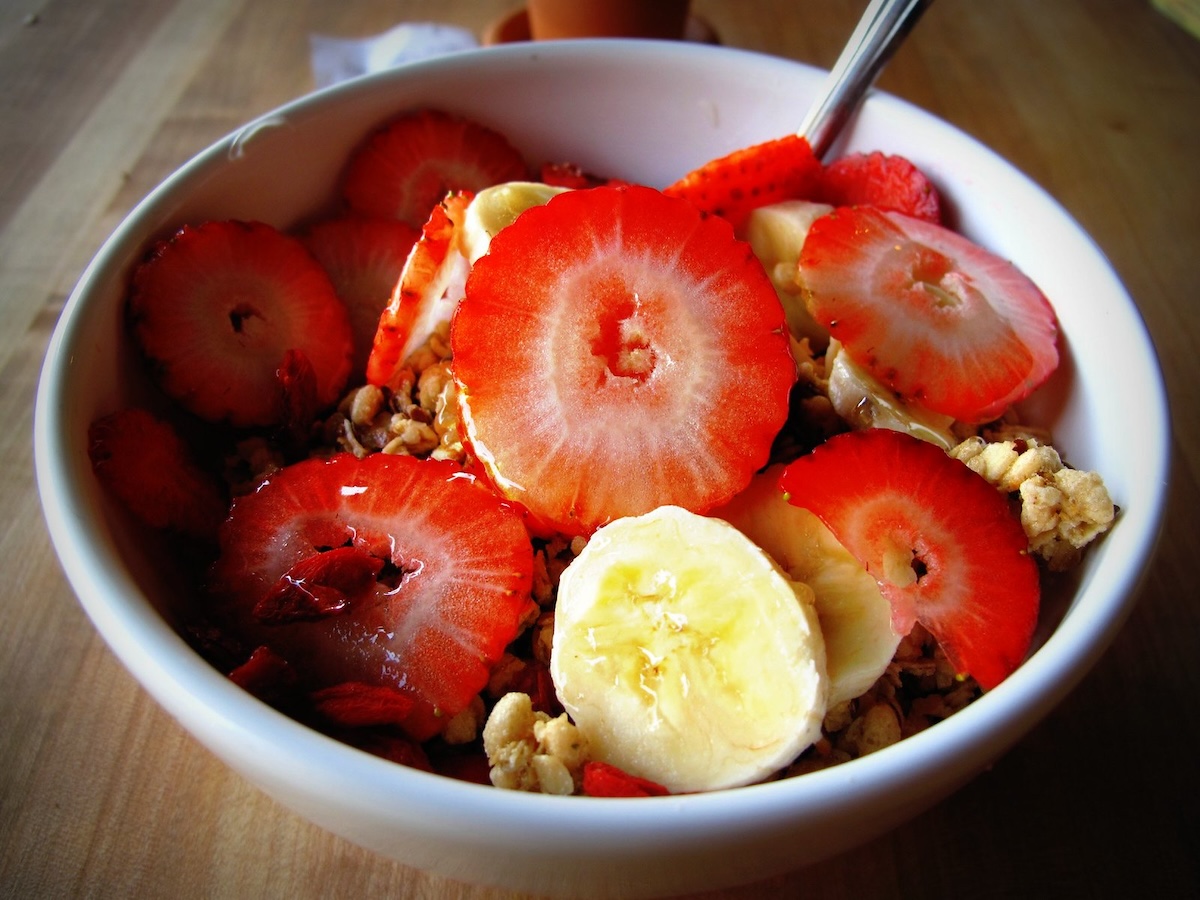 Close-up of an A&ccedil;a&iacute; bowl with strawberries, muesli or granola and bananas.