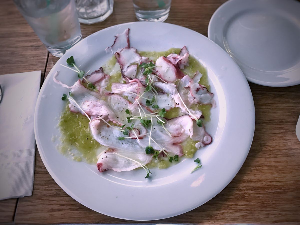 A ceramic plate with octopus carpaccio