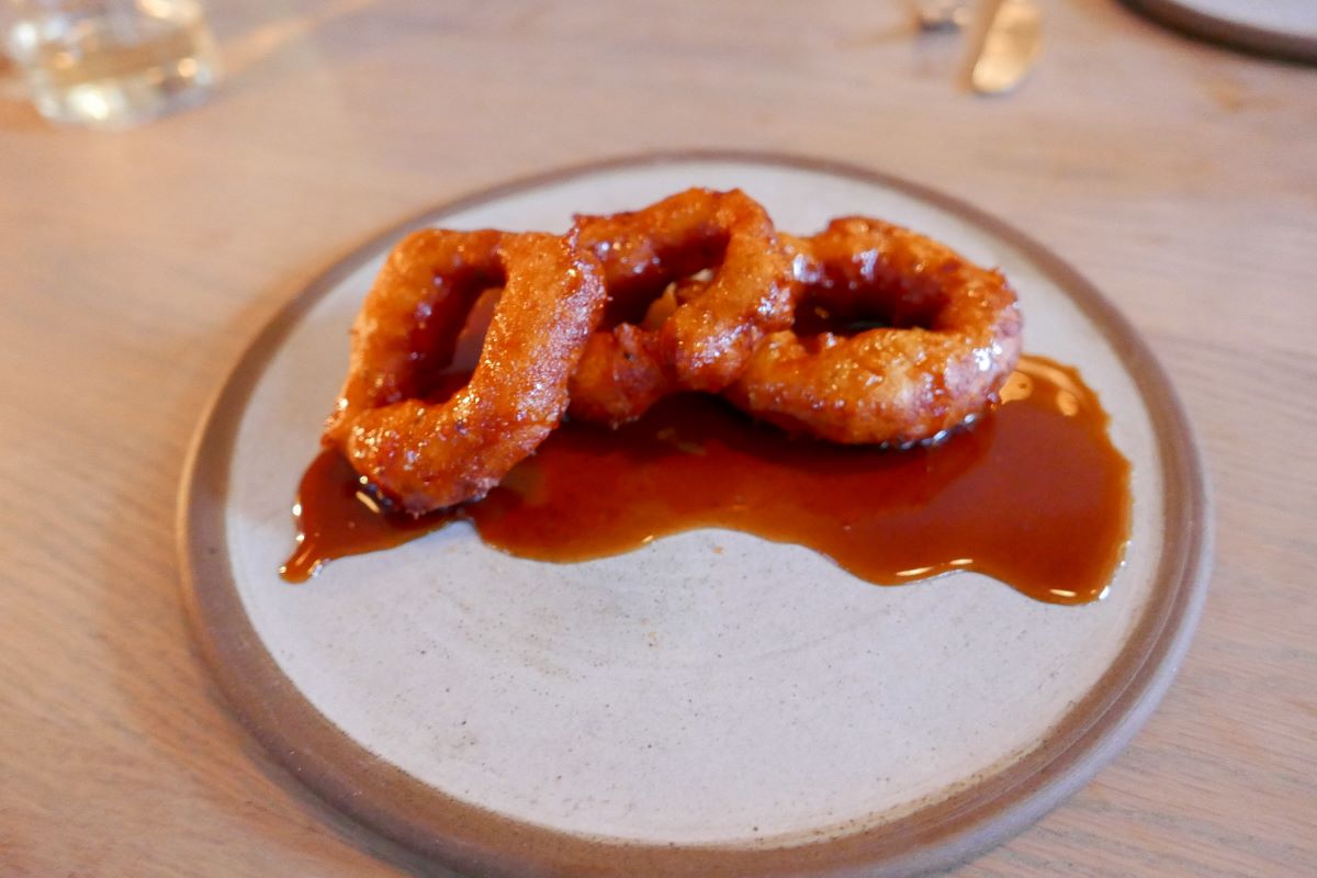 Picarones drizzled with a sweet caramel sauce. 