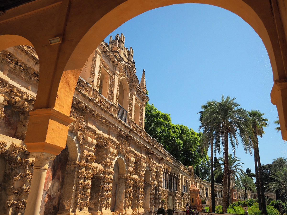 View out to the gardens from beneath the awning of Royal Alc&aacute;zar of Seville