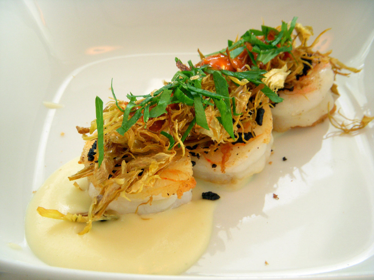 extreme close up of a plate of sauteed shrimp in a restaurant 