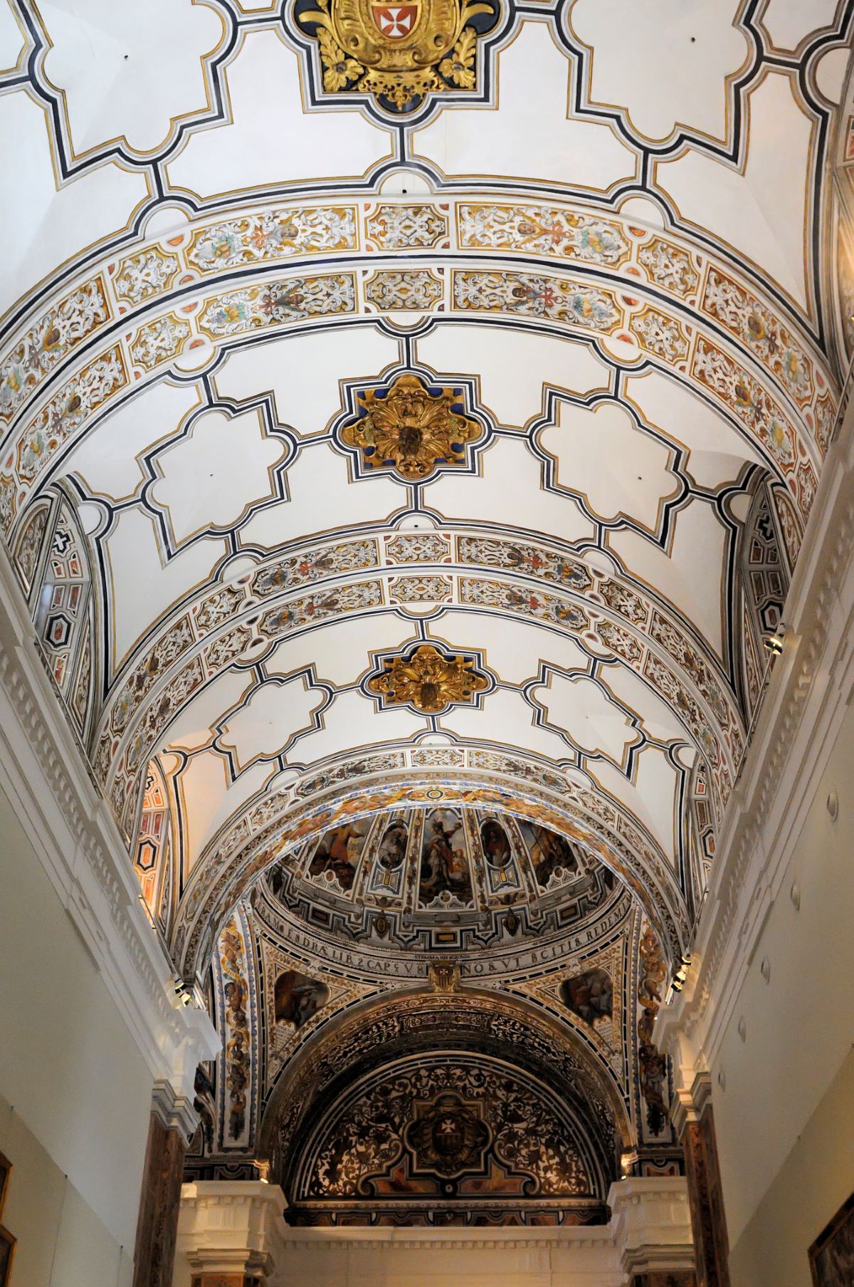 The Fine Arts Museum in Seville's vaulted ceiling with decorative plasterwork and baroque motifs.