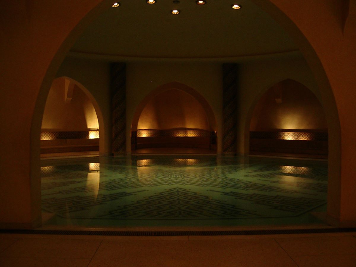 An ancient hammam with a pool of water. 