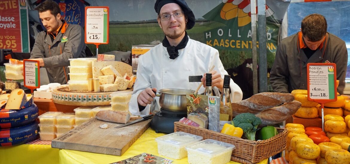 Cheese, bread, wine, and fondue vendor at a food market in Amsterdam