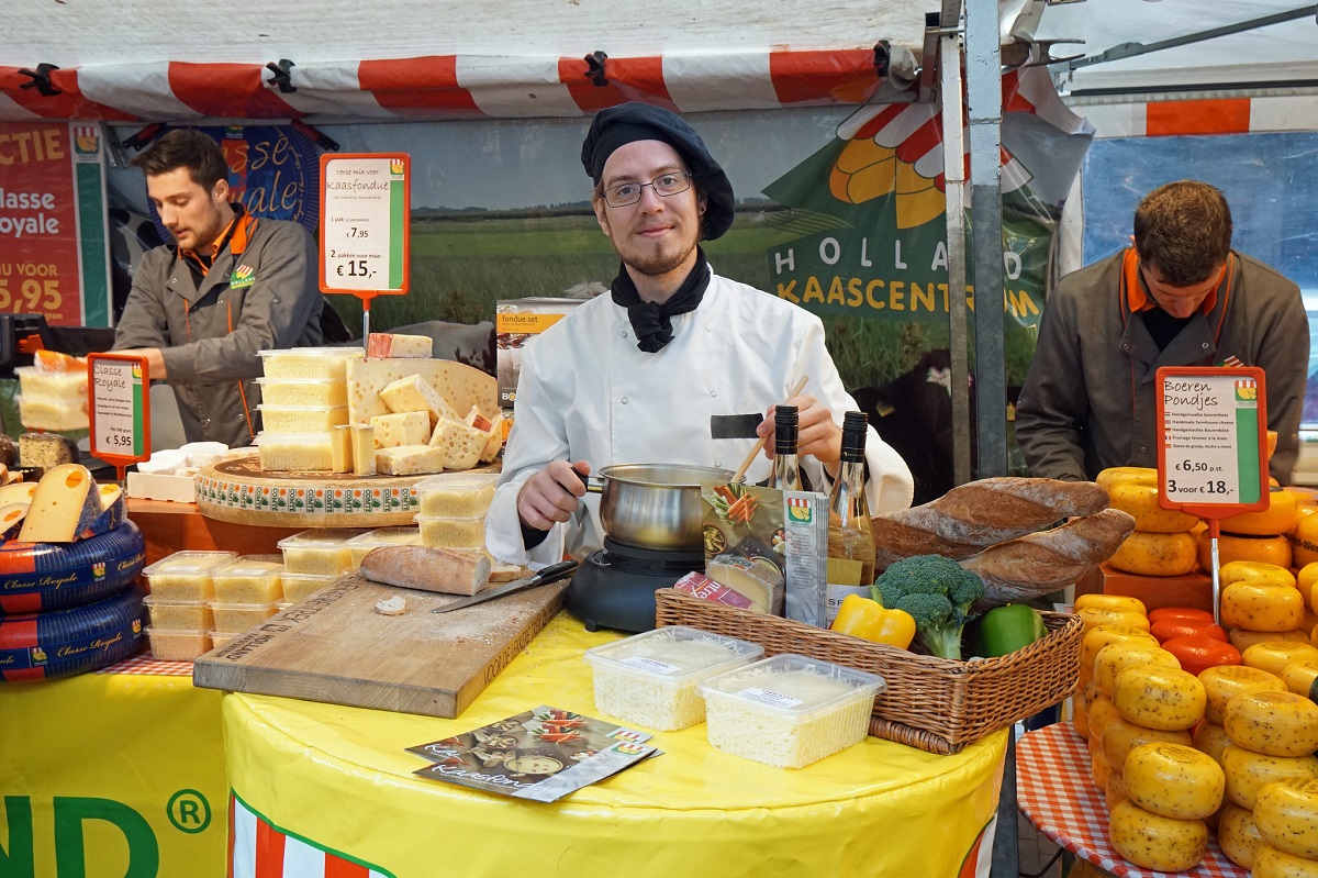 Cheese, bread, wine, and fondue vendor at a food market in Amsterdam
