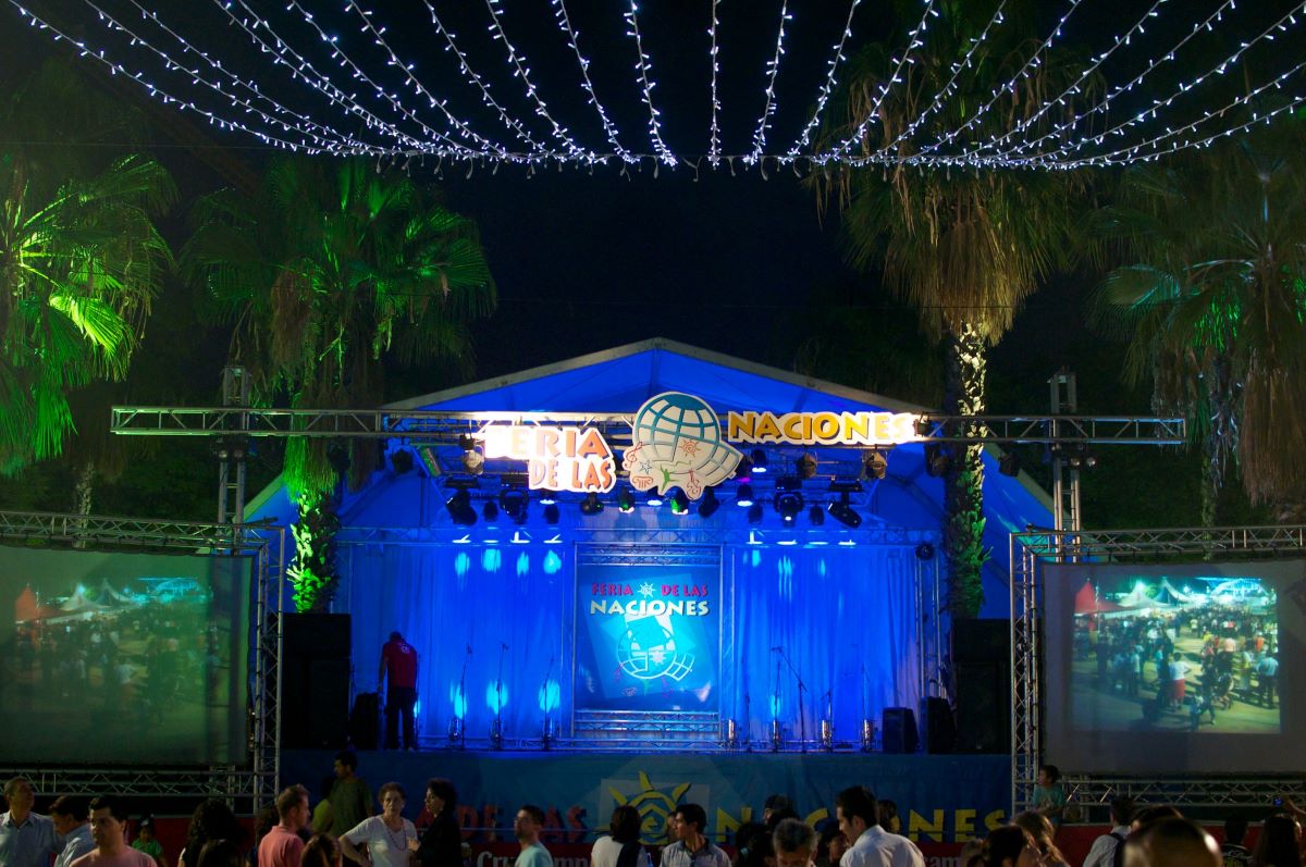 People at a stage at Festival de las Naciones listening to music. 