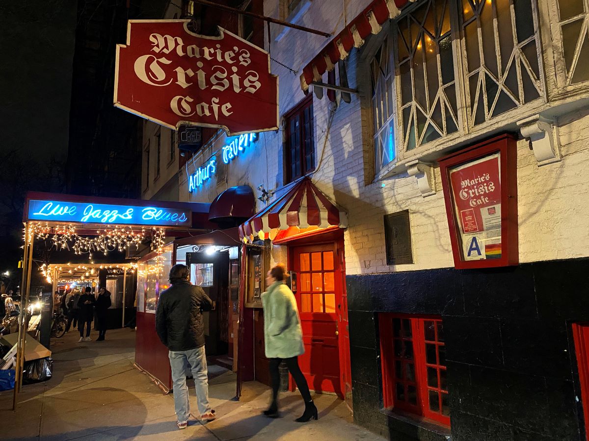 Two people walking out of Marie’s Crisis in New York City. 