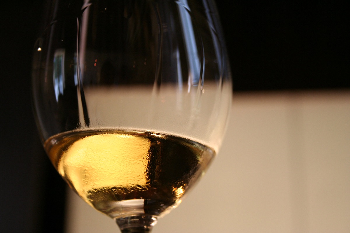 Close up of white Sauternes wine in a glass with wine tears