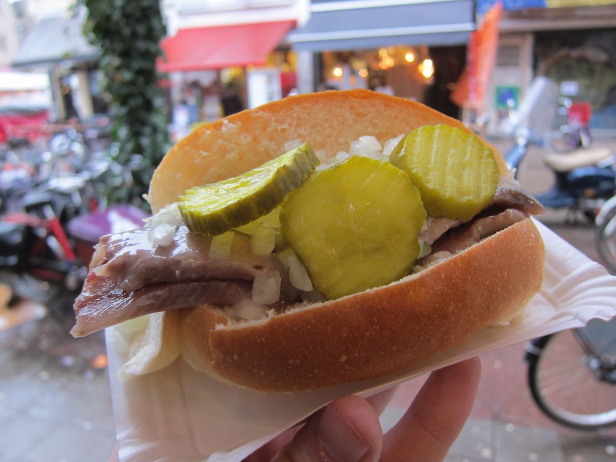 Herring served as a sandwich with pickles in Amsterdam. 