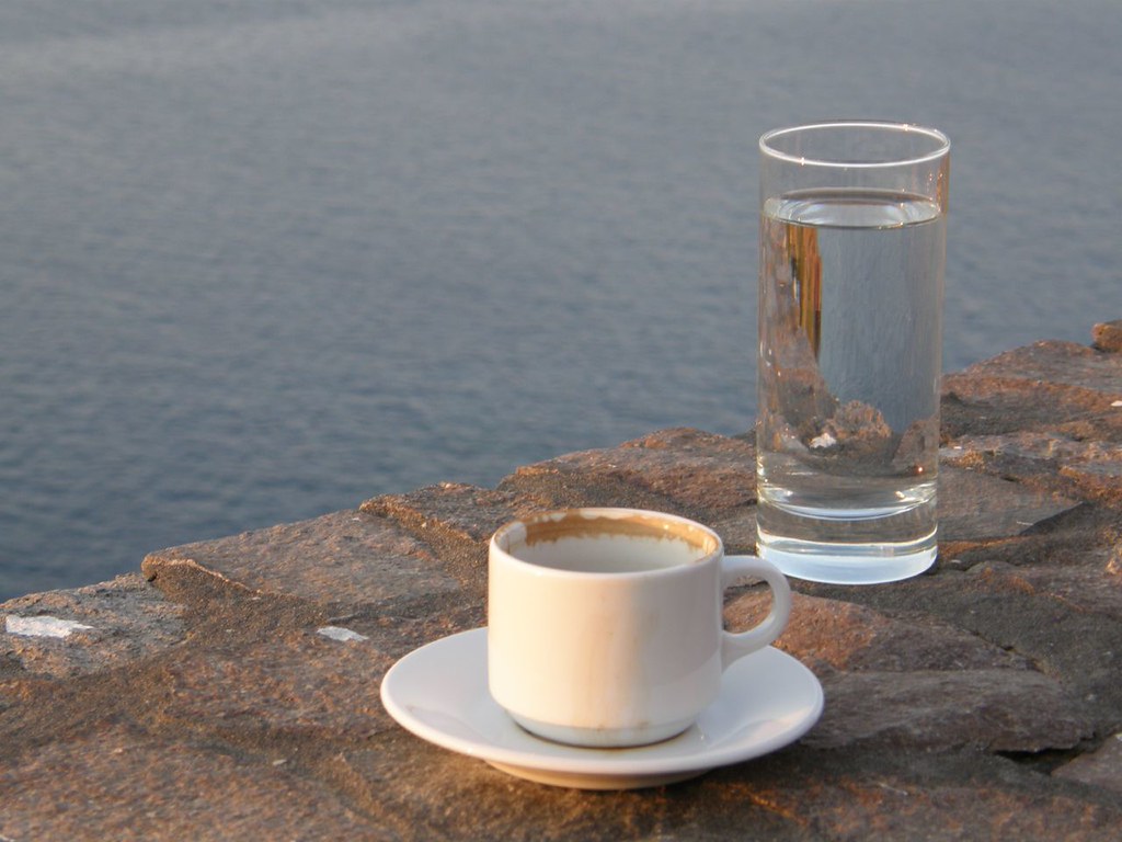 cup of coffee with sea in the background