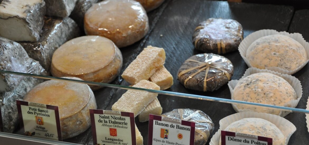 cheese displayed in the case at Androuet, one of the best cheese shops in Paris.