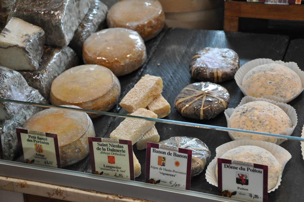 cheese displayed in the case at Androuet, one of the best cheese shops in Paris.