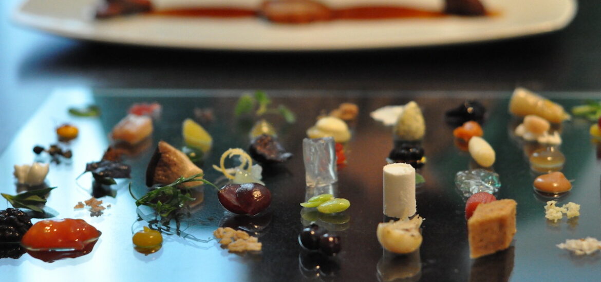 Close up of a dish at Alinea, a restaurant in Chicago, with dozens of tiny bites