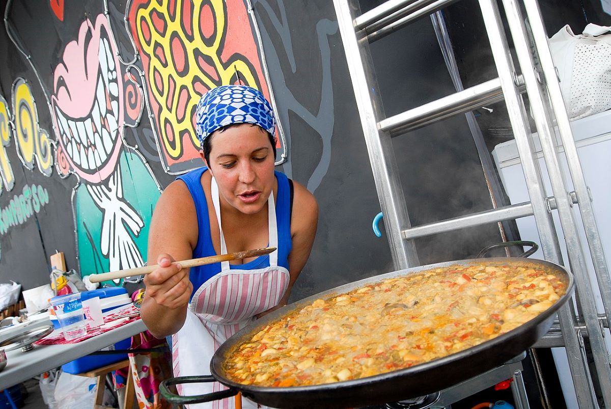 A woman tasting paella in a Paella competition in Plaza Cataluña, San Sebastian. 