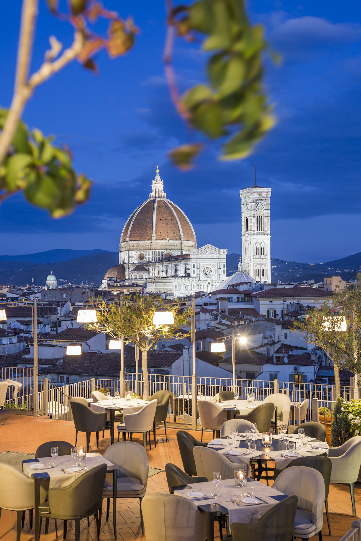 View of the Florence cathedral dome from a rooftop bar at night