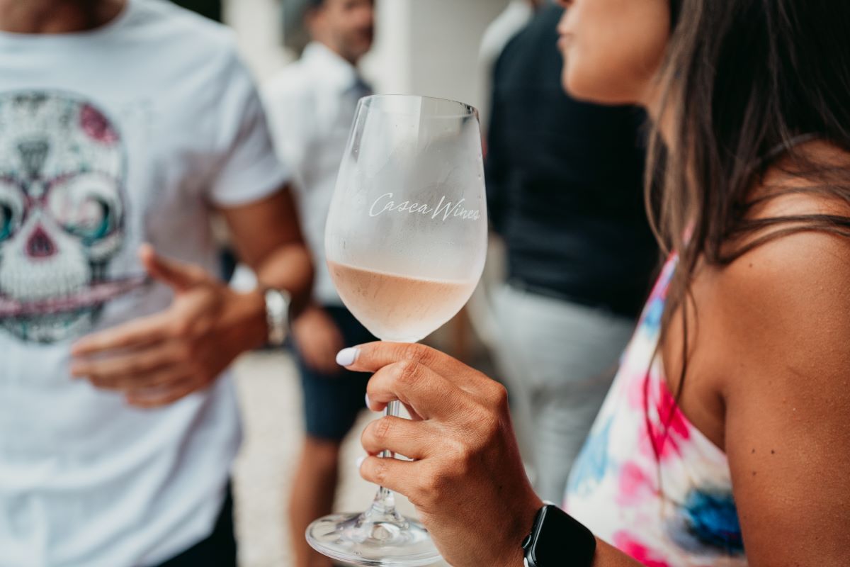 woman holding glass of rose wine