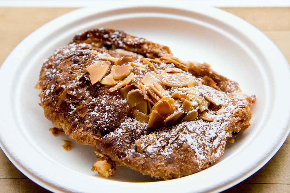 Chocolate almond croissant on a white plate