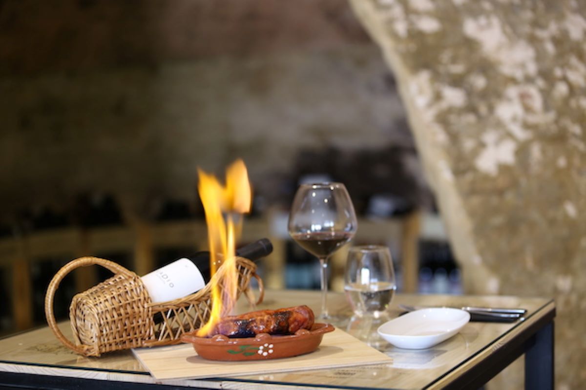 table with plate of burning sausage