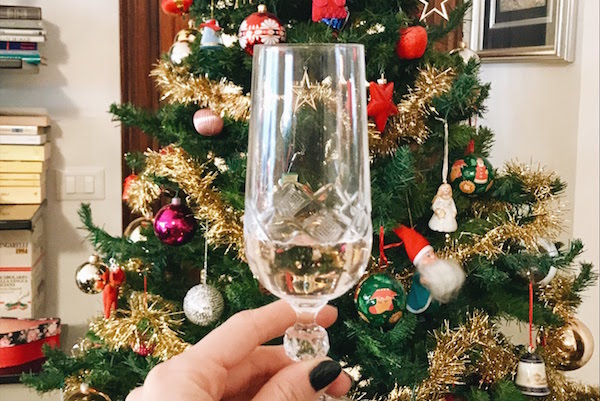 Glass of wine in front of Christmas tree