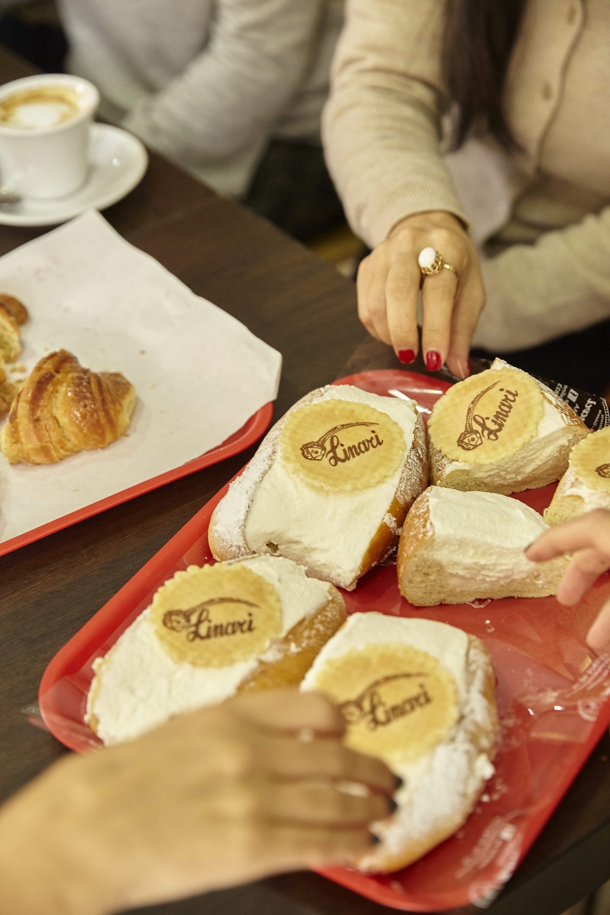 Four pastries on a red tray