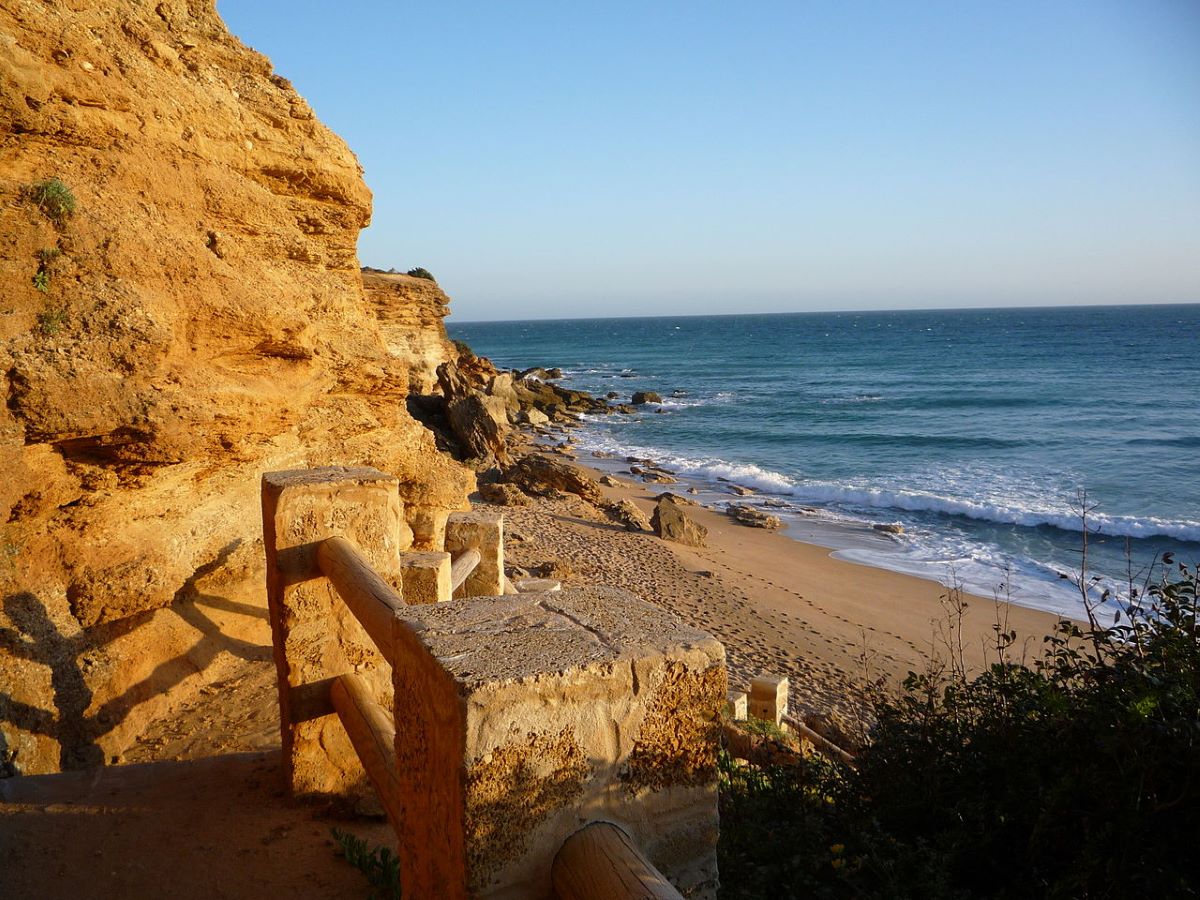 Rocky cliffs next to a beach in Calas de Roche. 