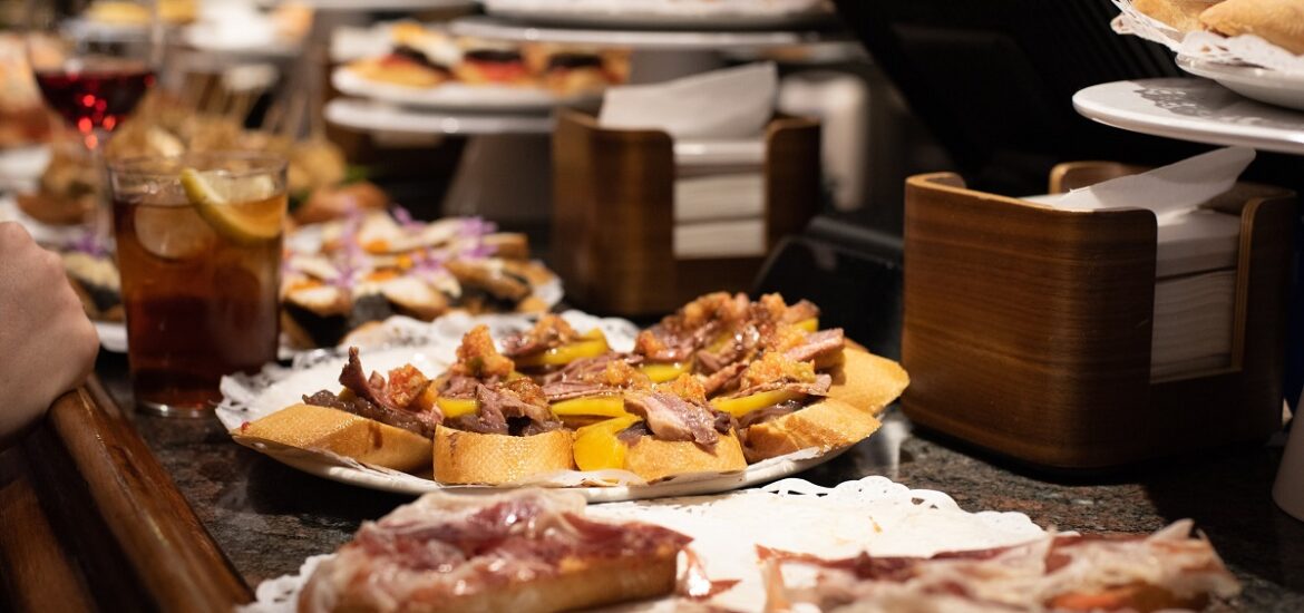 Pintxo bar in San Sebastian with counter stocked with several varieties of toast