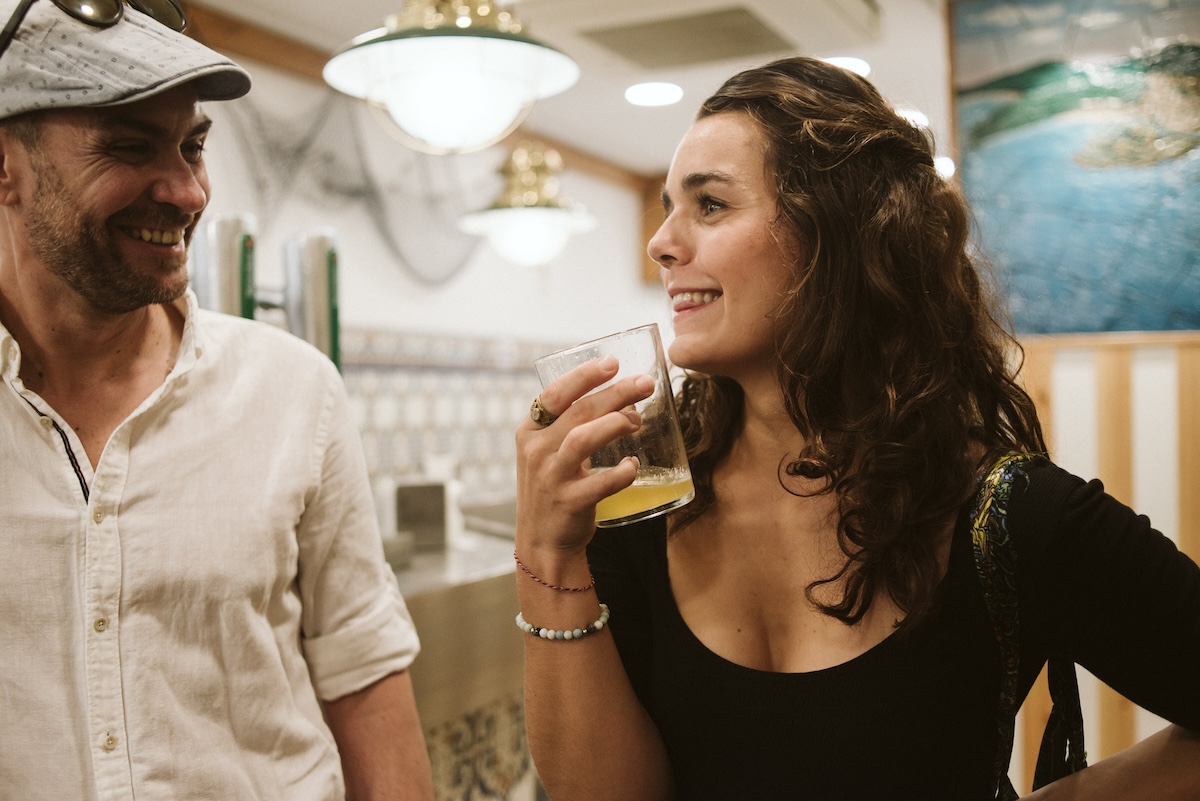 man and woman talking inside a bar