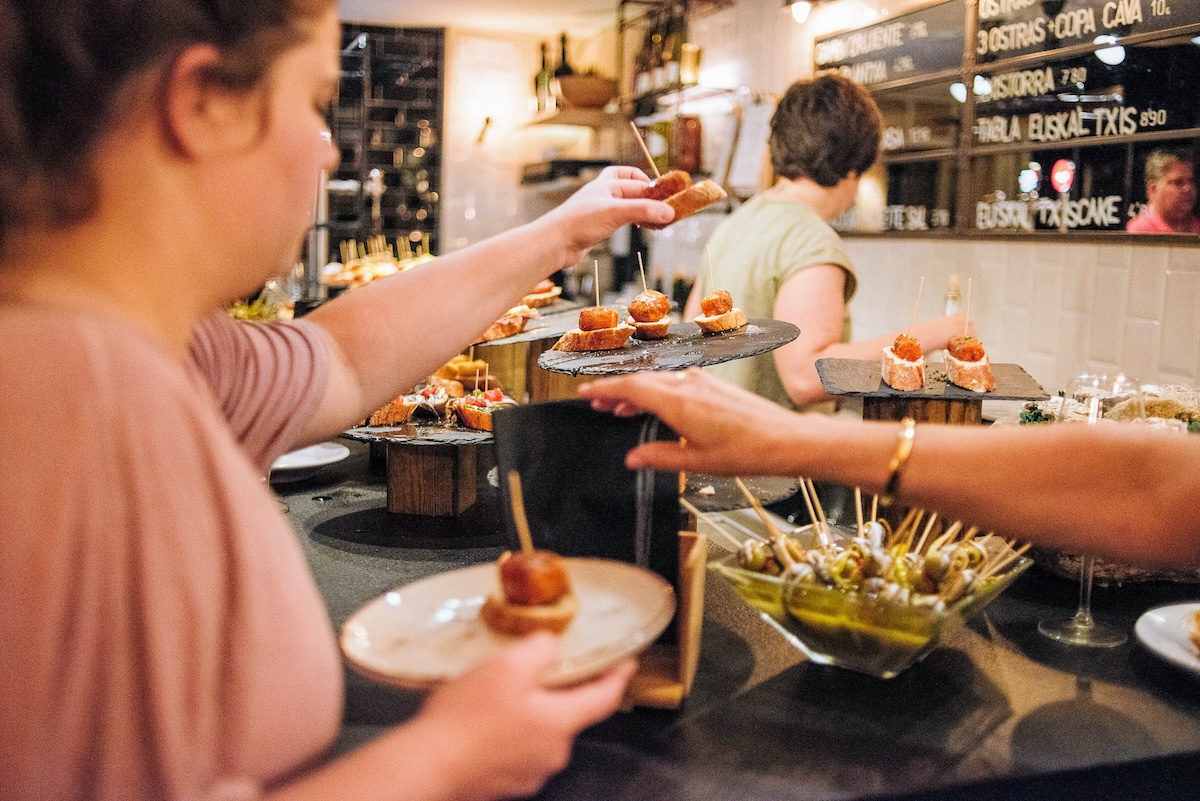 woman grabbing a pintxo