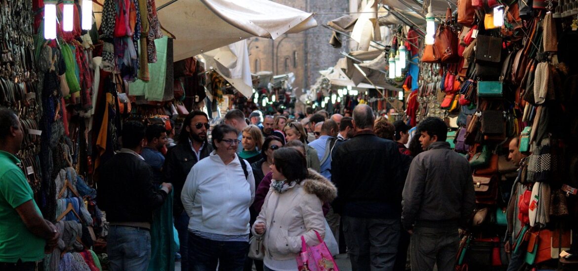 Shoppers in Florence check out a busy outdoor flea market