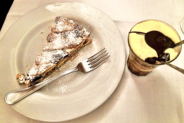 Two delicious desserts in Rome are pictured here: a pie made with ricotta cheese and tart cherries, and the traditional tiramisu.