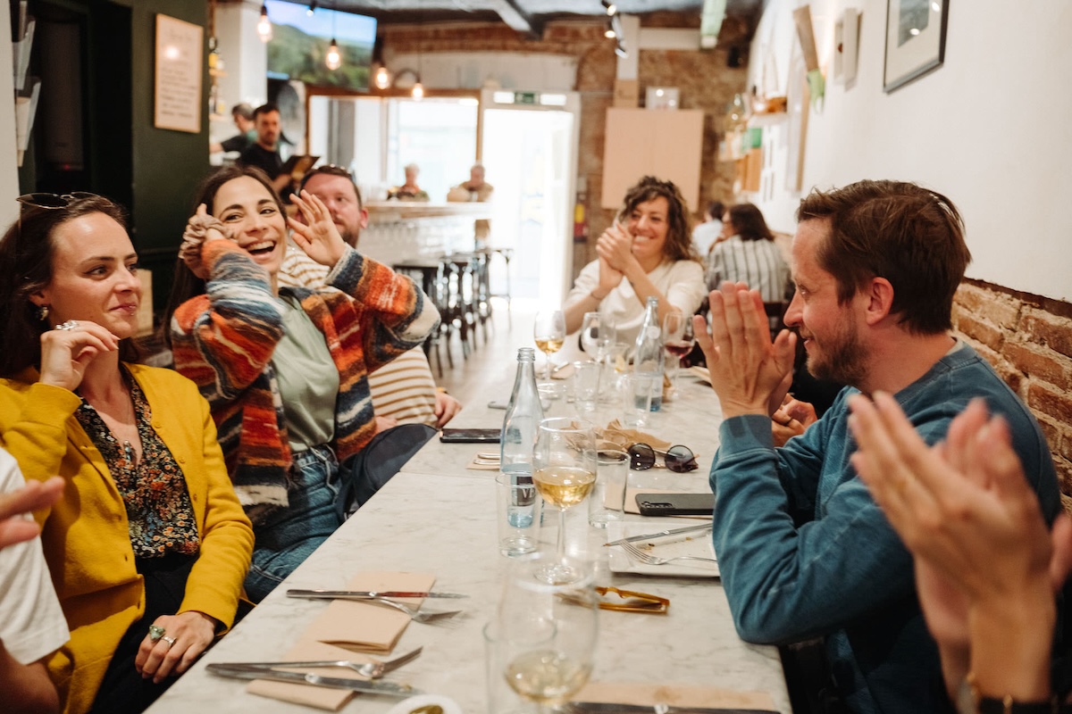 group of people enjoying a moment around a long table