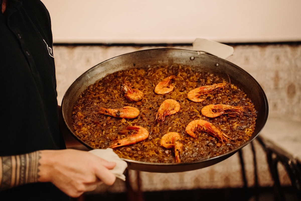 large pan of cooked paella topped with shrimp