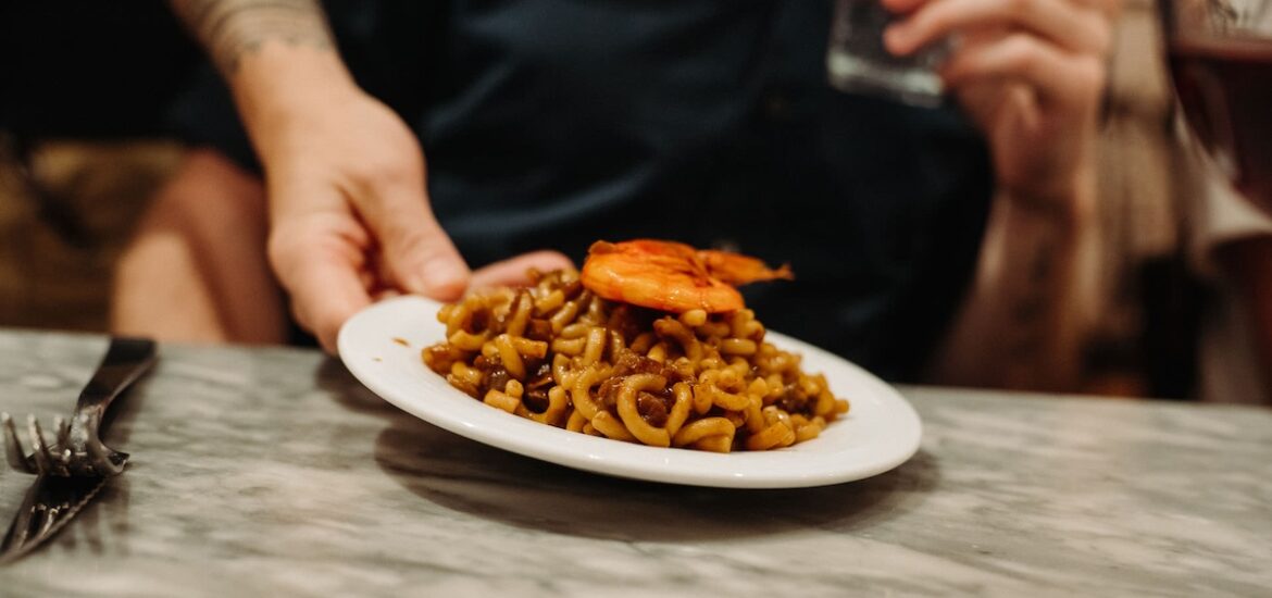 small plate of pasta with shrimp on top