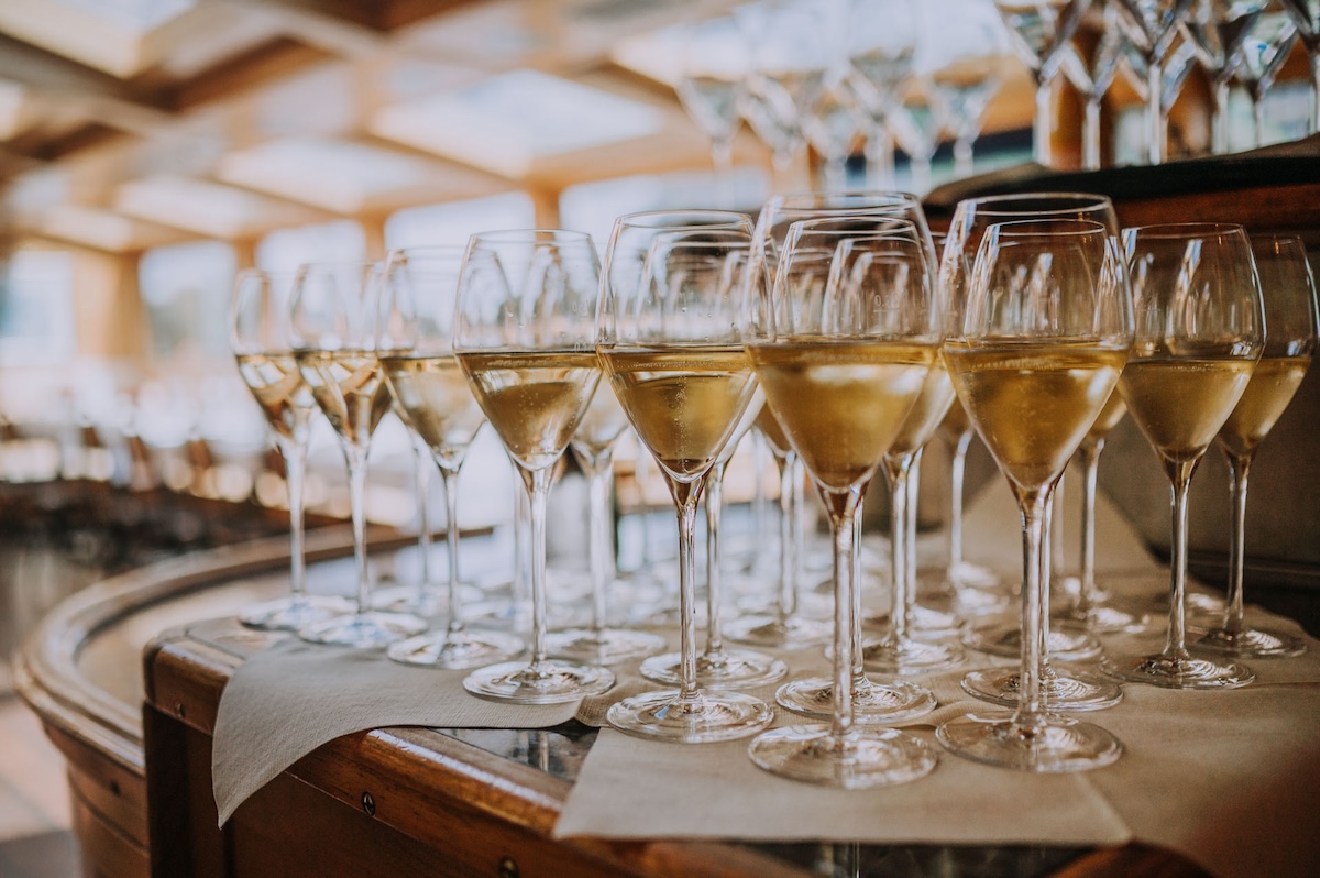 several glasses of white wine lined up