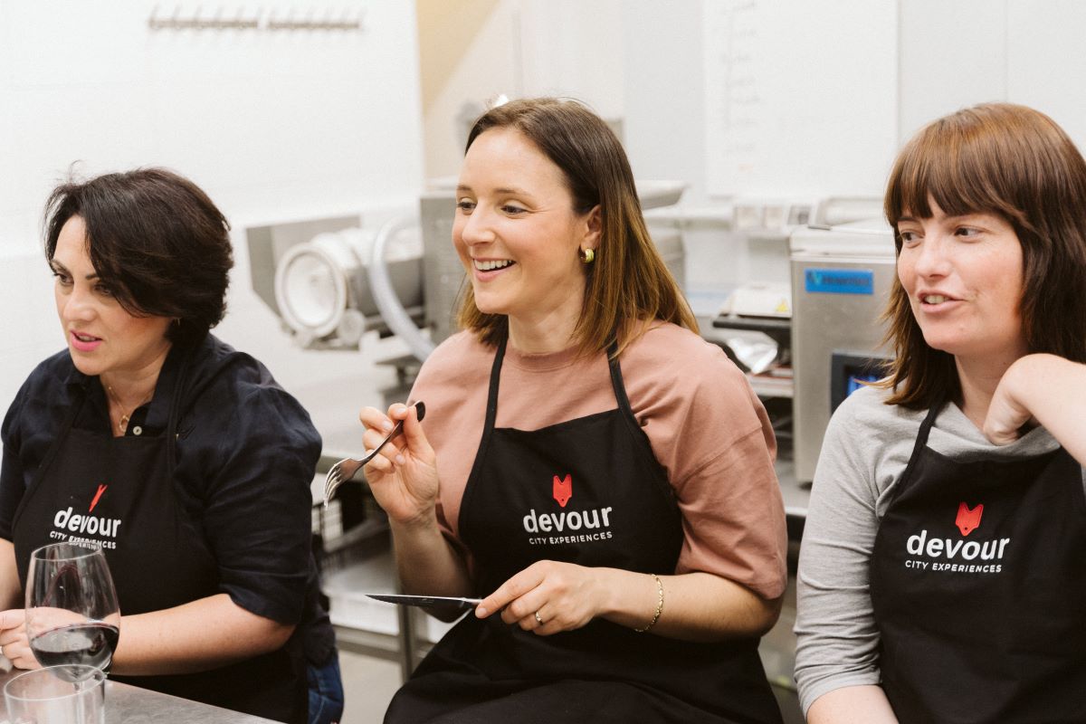 A group sits together for a demonstration during a cooking class