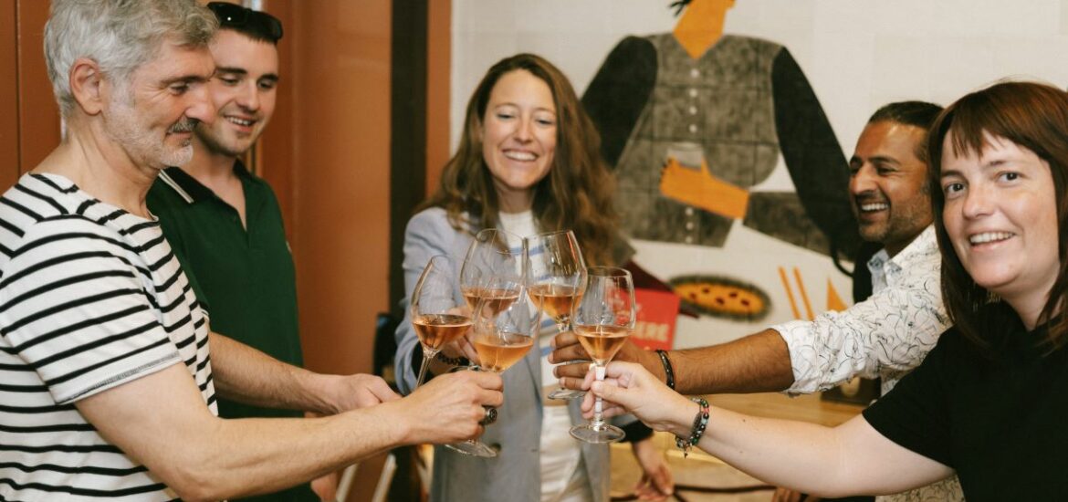 A group does a cheers with wine