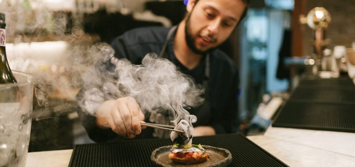 A chef plating a dish at a restaurant in San Sebastian.