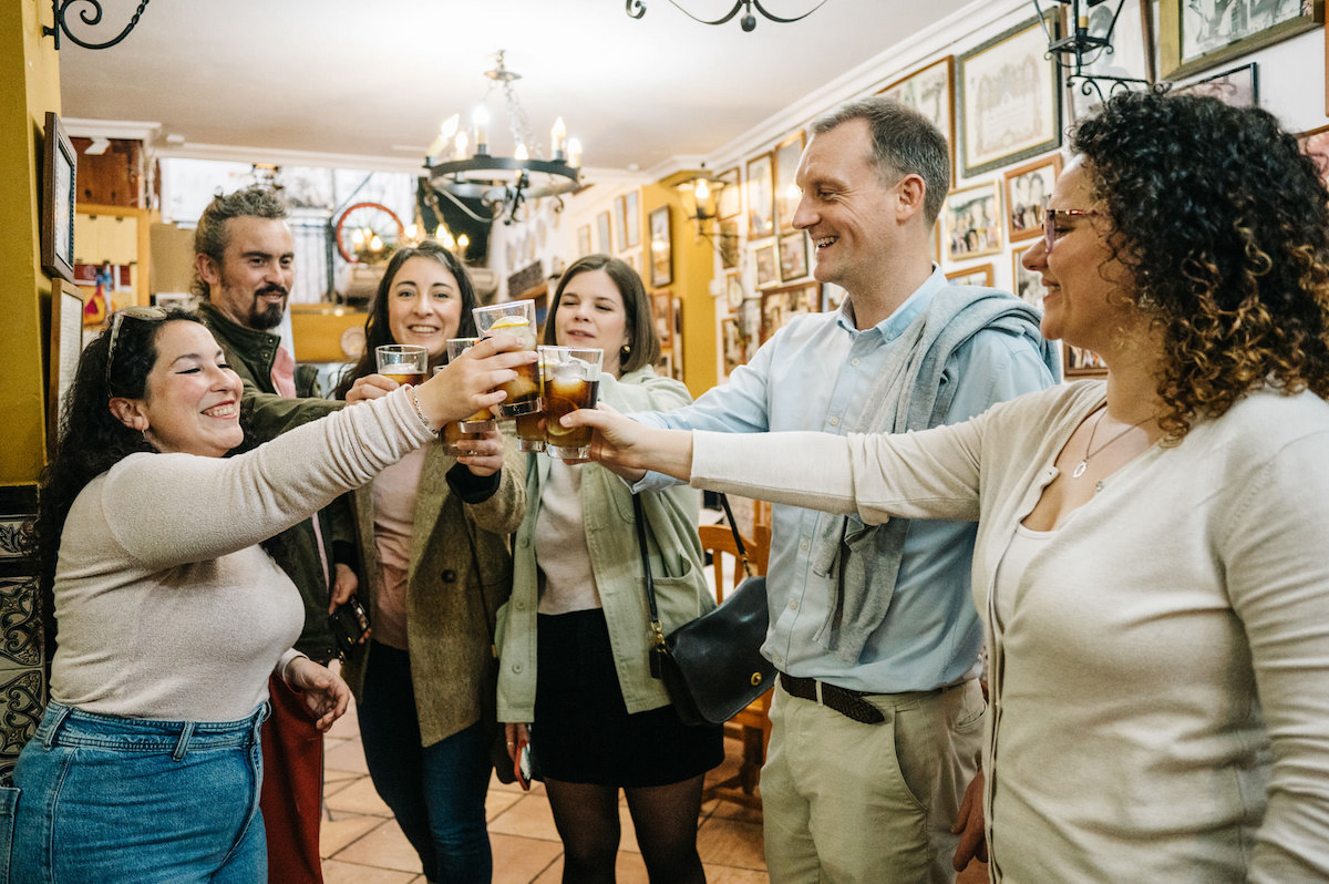 People toasting in one of the best wine bars in Seville