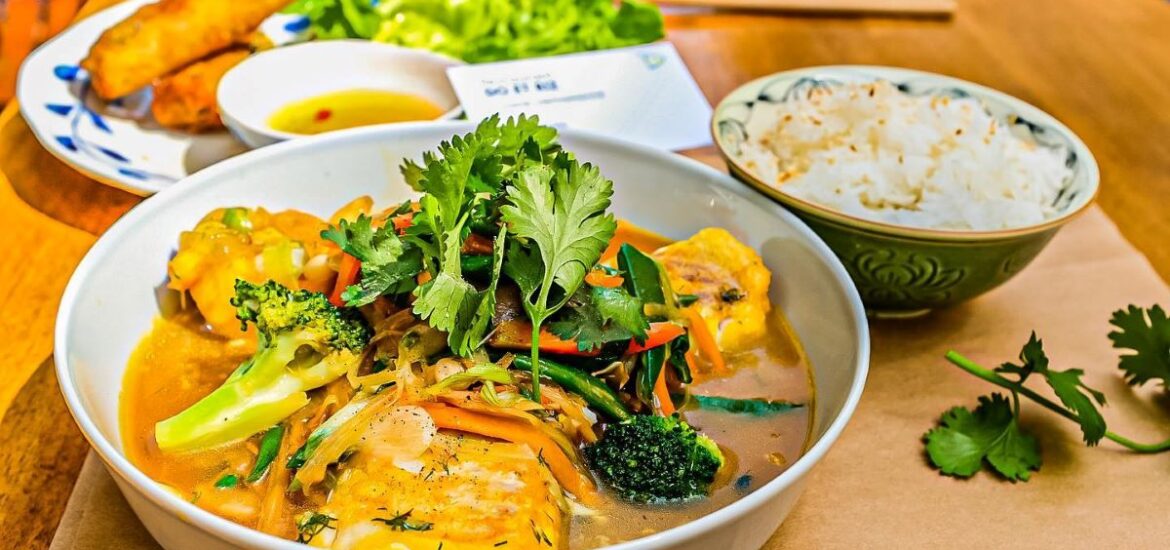 table with various bowls of Vietnamese food.