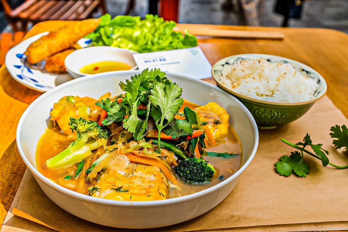 table with various bowls of Vietnamese food.