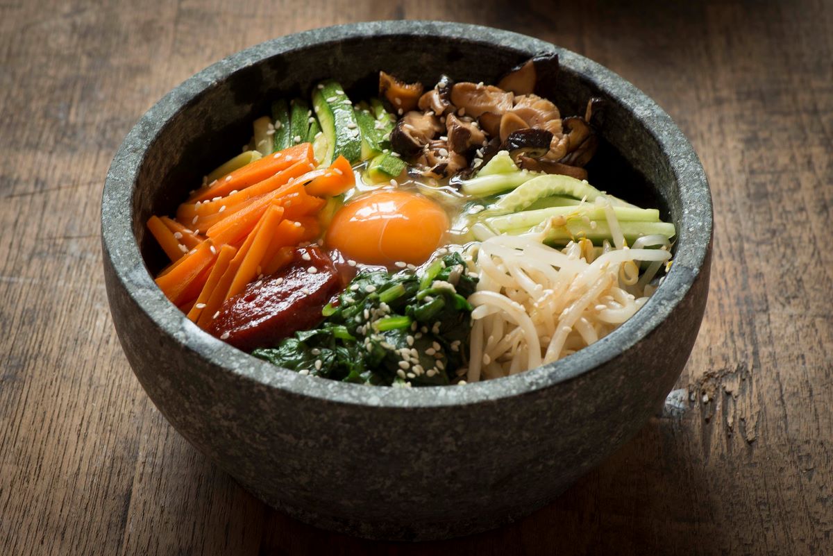 bibimbap Asian vegetables in black bowl