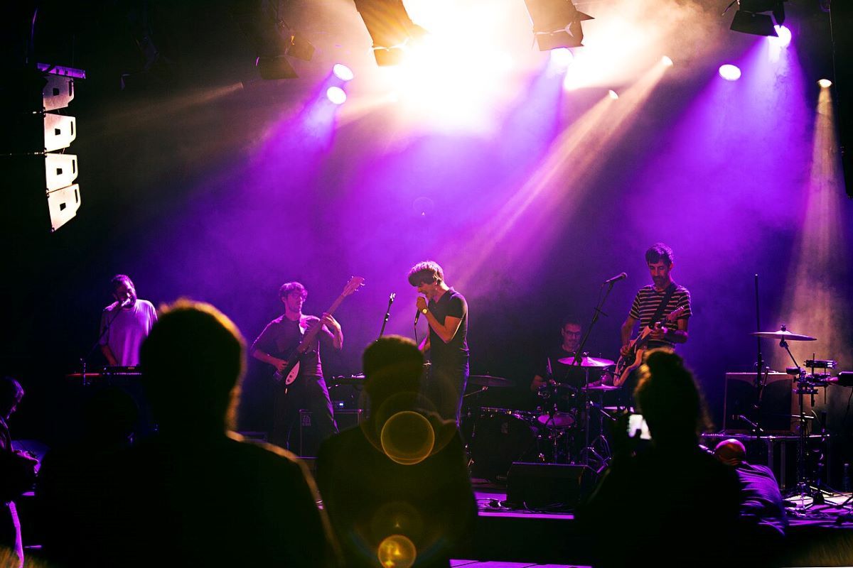 A rock band playing on a stage at Donostia Festibala. 