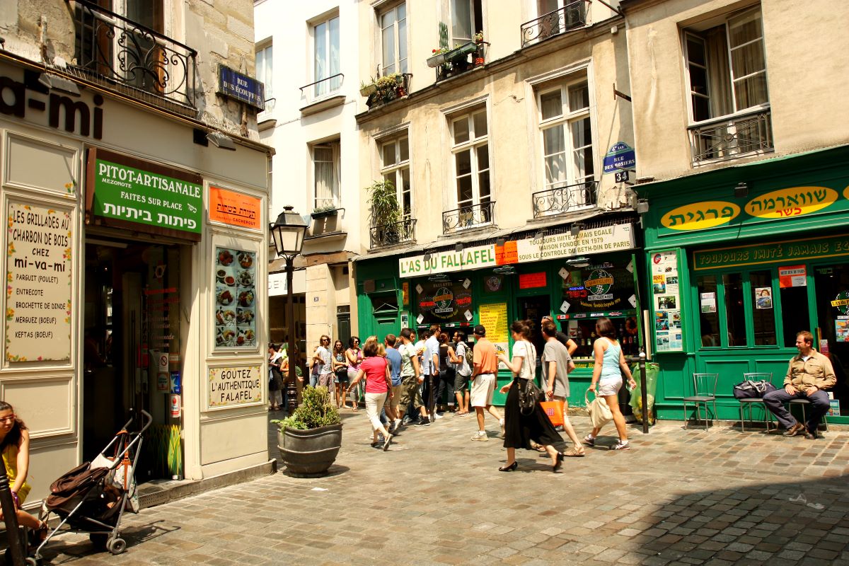 A busy street in Paris with many bustling restaurants to eat at on Christmas day.. 