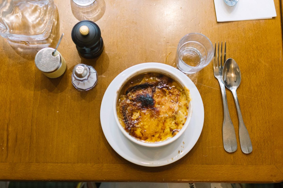 Bowl of French onion soup on a restaurant table