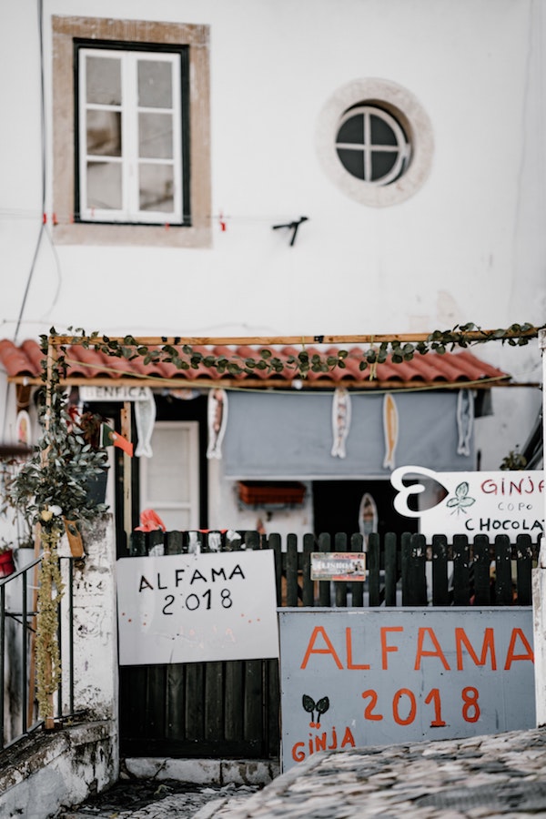 A sign in Lisbon's Alfama neighborhood advertises ginja served in a chocolate cup.